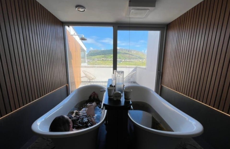 A woman in Voya's twin bath room