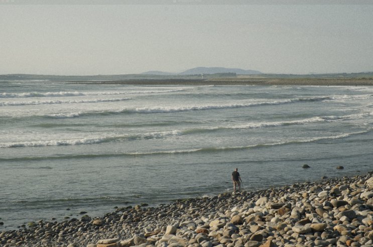 Man walks across the shore