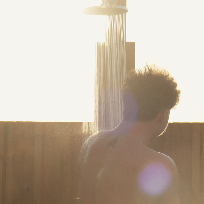 Guest showering outdoors at VOYA Seaweed Baths in Strandhill