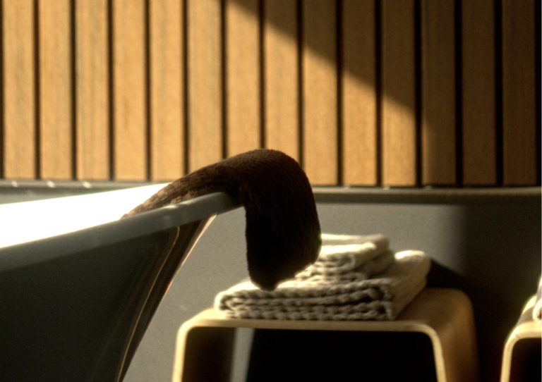 A bath with a towel at the end of it