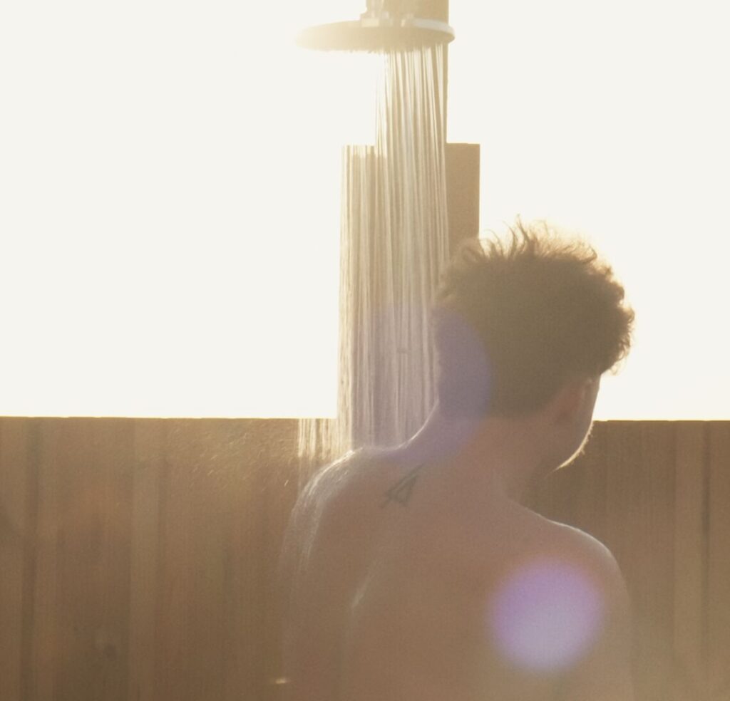Guest using an outdoor shower at VOYA Seaweed Baths