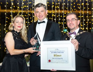 Three voya representatives smiling at an awards ceremony