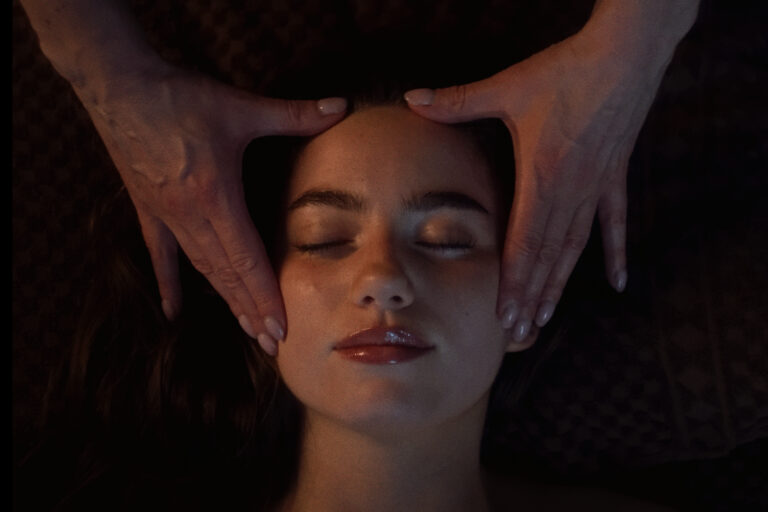 A woman receives a facial at VOYA spa