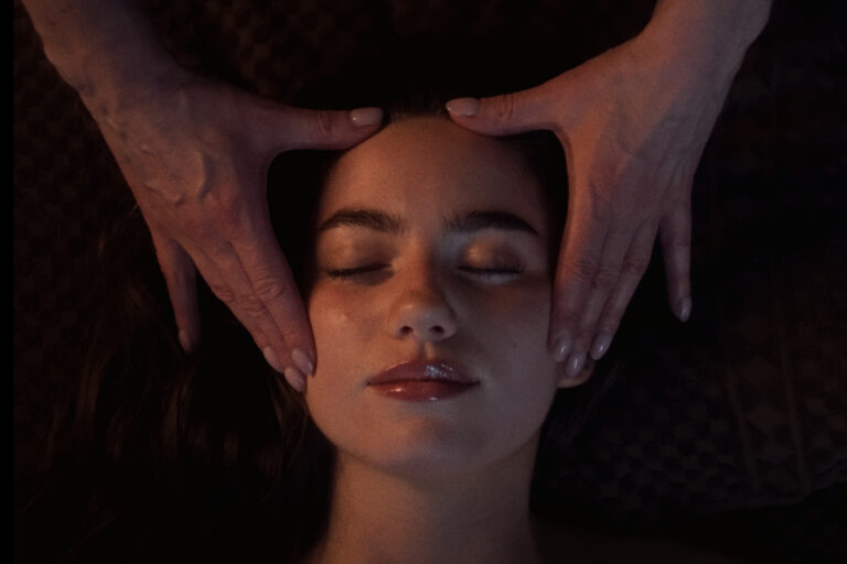 A woman receives a facial at VOYA spa