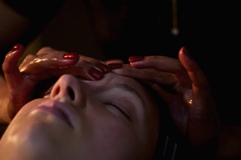 A woman receives a facial at VOYA spa