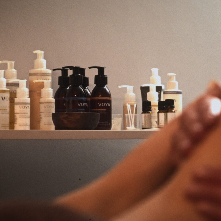 A woman receives a foot massage at VOYA spa