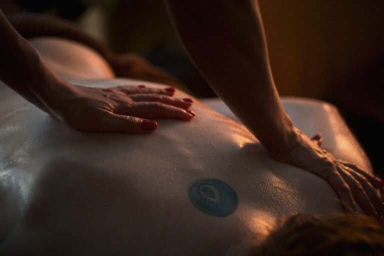 A man receives a back massage at VOYA spa